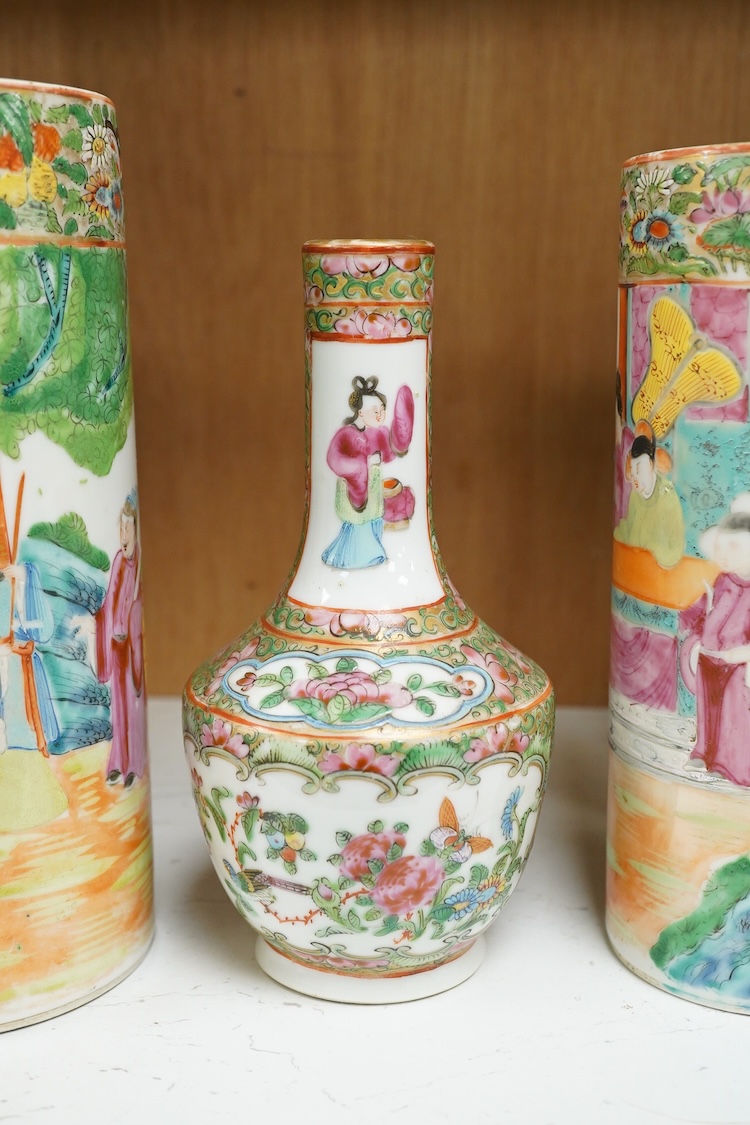 Two 19th century Chinese famille rose cylindrical vases and a similar bottle vase, 21cm
